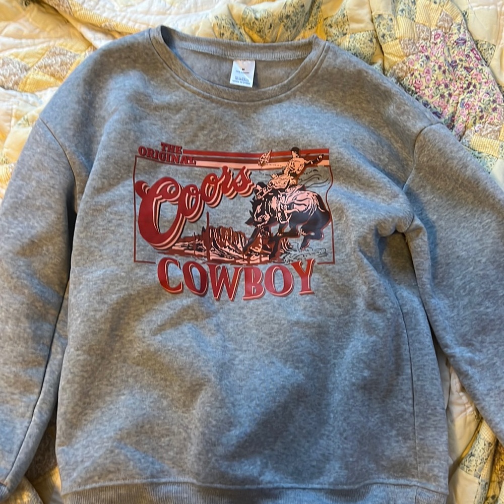 This is a “coors cowboy” sweatshirt that has never been worn!